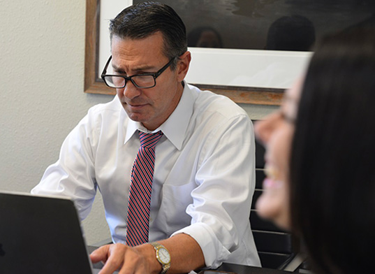 Mediator Jeff Lieser reviews the points of a mediation case at his Tampa office.